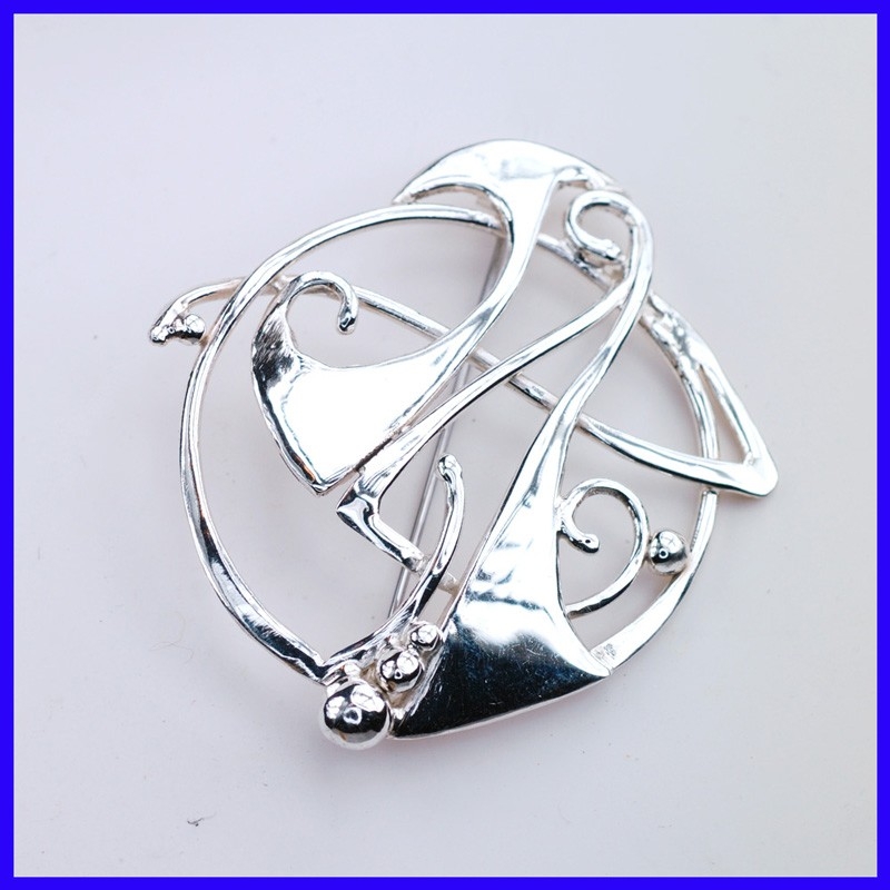 Fancy brooch in pure silver. Jewel of a handmade designer. Fancy brooch in pure silver. Jewel of a handmade designer.