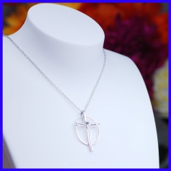 Pendant in the shape of a silver cross. Handmade jewelry by a jewellery craftsman