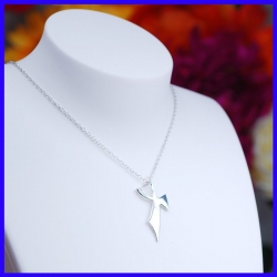 Pure silver pendant in the shape of a cross. Handmade designer jewelry