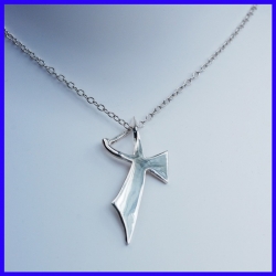 Pure silver pendant in the shape of a cross. Handmade designer jewelry