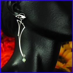 Earrings made of silver and a green calcite bead. Designer and handmade jewel.