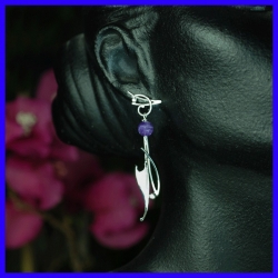 Pair of hanging silver earrings topped with amethyst. Handmade jewelry.