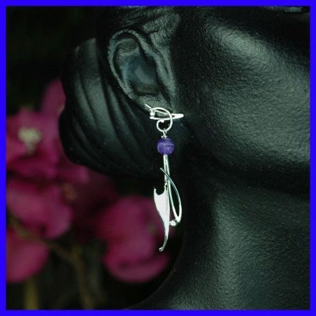 Pair of hanging silver earrings topped with amethyst. Handmade jewelry.