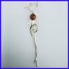 Thin hanging earrings adorned with a Tiger Eye pearl. Fashion jewellery.