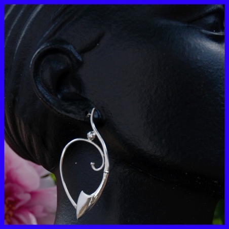 Pair of silver creole earrings. Jewelry designer for women.