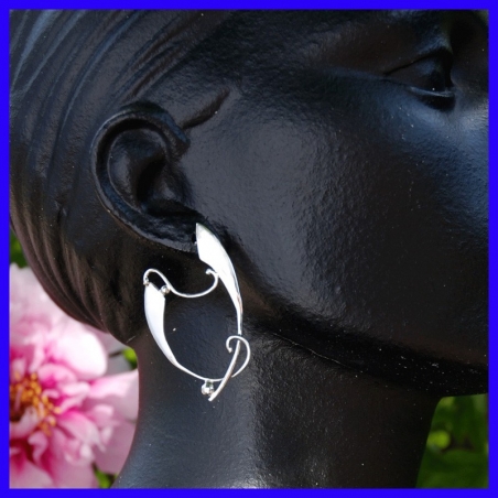 Pair of silver creole earrings. Jewelry designer for women.