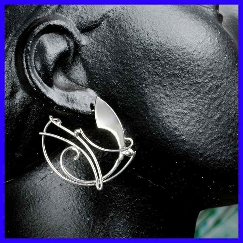 Pair of silver creole earrings. Jewelry designer for women.